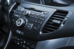 Compact Disc Storage Medium Prints: Control panel and cd in a modern car