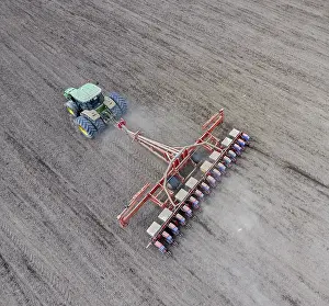 Farming Machine Prints: Corn seeder. Sowing on the field with a seeder of corn