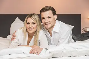 Couple Embracing In Bed Prints: Couple lying on a bed