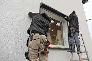 Professional Window Installation Prints: Craftsmen install a front-mounted roller shutter