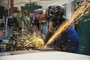 Workplace Safety Equipment Prints: Craftsmen working with an angle grinder in his workshop