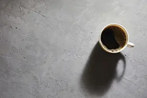 Appetizing Dish Prints: Cup of coffee on a gray background top view