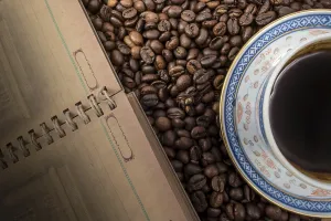 Coffee Background Prints: Cup of coffee and notebook on coffee background