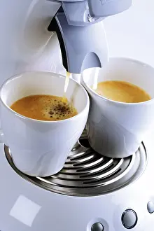 Coffee Still Life Prints: Two cups placed under an espresso machine