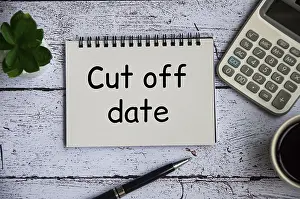 Time Pressure Image Prints: Cut off date text on notepad with table plant