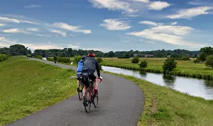 Cycle Path Germany Prints: Cyclist on a cycle path by the river