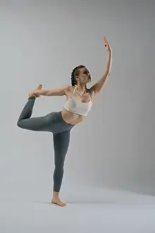 Minimalist Studio Shot Prints: A dancer showcases her flexibility and strength while executing an elegant pose in a studio