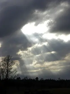 Dark Storm Clouds Prints: Dark storm clouds with rays, sunrays burst through