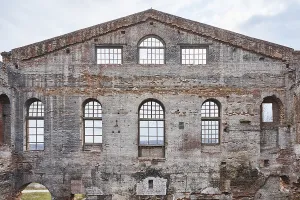 Abandoned Architecture Prints: Decayed facade of an old brick building with arched windows