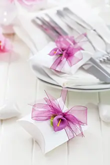 Elegant Meal Service Prints: Decorated table in white with small present for the guests