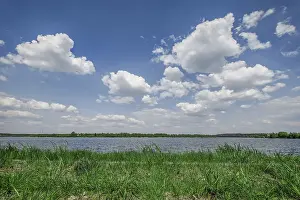 Deep Blue Sky Prints: Deep blue sky with clouds over the river