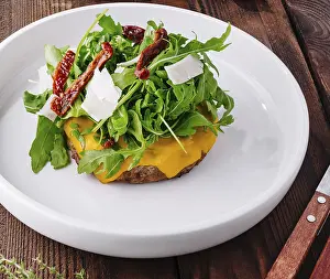High Calorie Meals Prints: Delectable cheeseburger topped with arugula