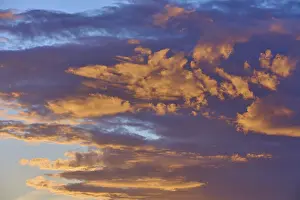 Evening Sun Over Bavaria Prints: Dense clouds in deep orange and blue in dramatic light in the evening sky