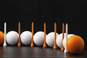 Athletic Sport Equipment Prints: Different golf balls on the black table