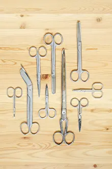 Sailing Sports Equipment Prints: Different types of scissors lying on wooden surface