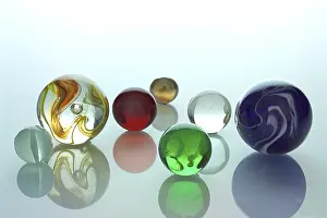 Empty Space For Text Copy Room Prints: Several differently colored marbles on a mirror surface