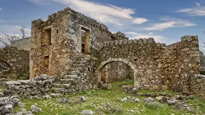 Eroded Landscape Canyon Prints: Dilapidated structure of ancient ruins under a sky with clouds
