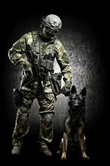 German Shepherd Breed Prints: Dog handler posing in the studio with a trained shepherd