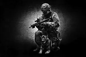 German Shepherd Breed Prints: Dog handler posing in the studio with a trained shepherd