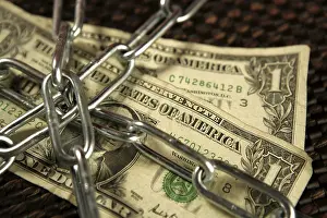 Brown Background Studio Shot Prints: One Dollar notes in chains studio shot over brown background