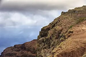 Steep Coastal Region Prints: Dramatic cliffs above the sea under a cloudy sky