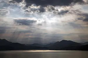 Lago Maggiore Italy Prints: Dramatic cloud formation, sunbeams behind dark clouds