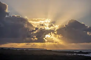Volcanic Rock Coast Prints: Dramatic cloudy sky with sunbeams at sunset