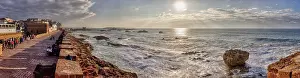 Evening Sun Landscape Prints: Dramatic coastline with strong waves and setting sun