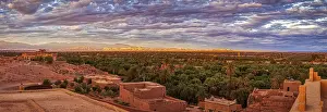 Desert Panorama Prints: Dramatic desert panorama with oasis and mountains in the background at sunset