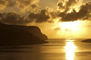 Uninhabited Shoreline Scenes Prints: Dramatic light mood, clouds, setting sun and the sea