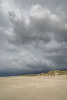 Deserted Sandy Ocean Beach Prints: Dramatic storm clouds over beach and dunes
