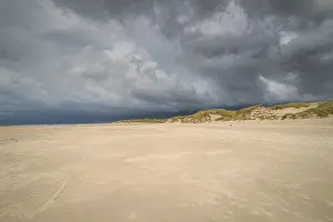 Cloudy Sky Over Dunes Prints: Dramatic storm clouds over beach and dunes