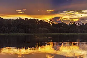 Dramatic Cloudy Skies Prints: Dramatic sunset with clouds over a river in the Amazon