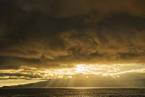 Soft Lightning In The Evening Sky Prints: Dramatic sunset with sun rays breaking through the clouds over the sea
