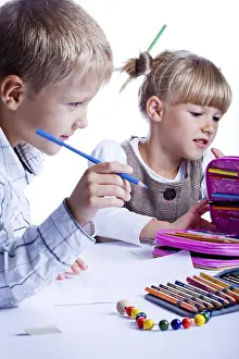 Book Prints: Two Schoolkids Drawing at a Table Print