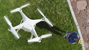 Air Traffic Control Drone Prints: Drone quadcopter (UAV) in air above pilot with remote controller