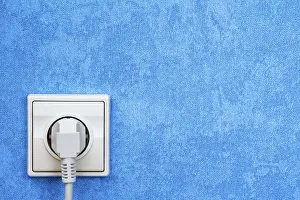 Power Supply Socket Prints: Electrical plug connected into the socket on blue wall