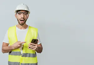 Young Adult Man Prints: Engineer using and pointing at cellphone