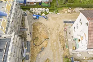 German Federal Republic Construction Sites Prints: Excavator and construction work on a plot of land next to a white building