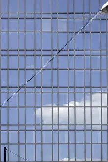 Modern Office Building Facade Prints: The facade of a modern office building with cloud reflections in the windows
The fa