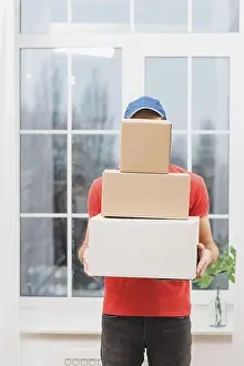 Courier Service Prints: Faceless courier with stack parcels