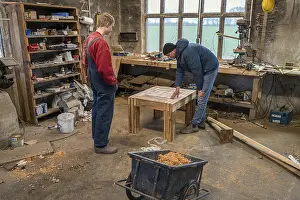 Father Son Quality Time Prints: Father and son looking at the table built by the son in the workshop