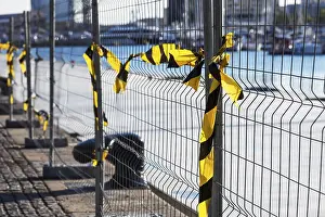 Deserted Building Site Prints: Fence with ribbons on a construction site