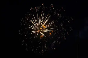 European Night Shot Prints: Fireworks with yellow-orange rays exploding in the night sky