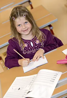 School Enrolment Process Prints: Firstgrader during a lesson