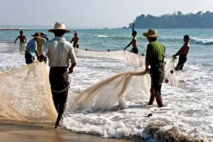 Travel Photography Beachfront Prints: Fishermen pulling a net on the beach