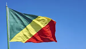 Prints of The flag of Congo flutters in the wind, isolated against a blue sky Related Prints: The Flag of Congo Print: Blue Sky Isolation