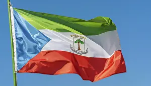 Prints of The flag of Equatorial Guinea flutters in the wind, isolated against a blue sky Equatorial Guinea Prints: The Flag of Equatorial Guinea Print