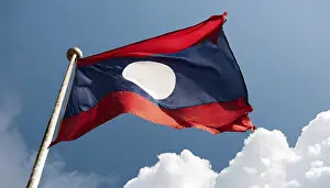 Blue Sky National Emblem Prints: The flag of Laos flutters in the wind