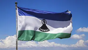 Blue Sky With Fluttering Flag Prints: The flag of Lesotho, fluttering in the wind